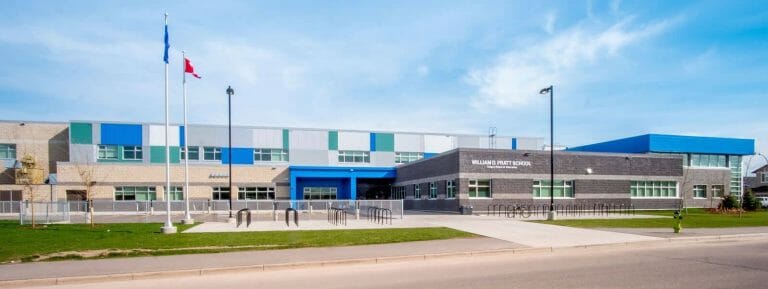 a building that has a sign on the side of a road