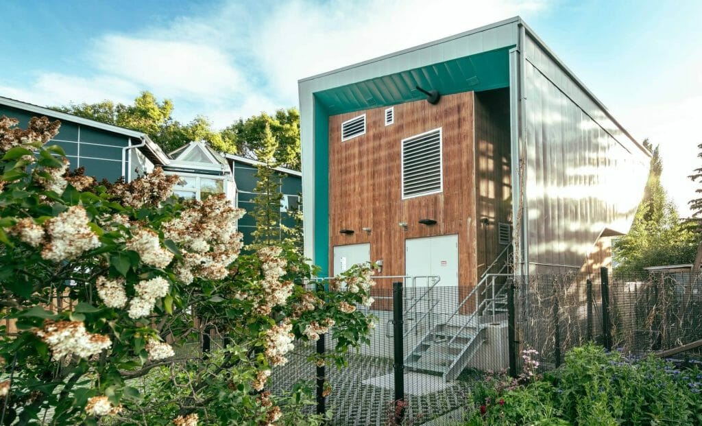 a house with a fence in front of a building