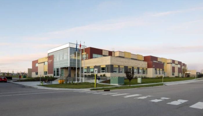 an empty road with a building in the background