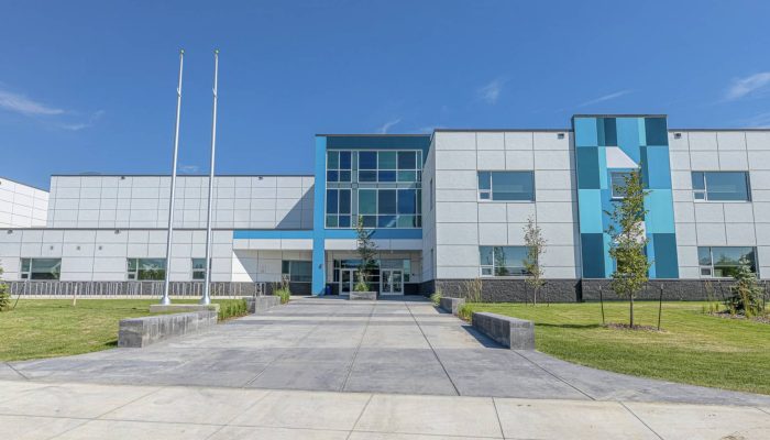 a building with a clock on the side of a road