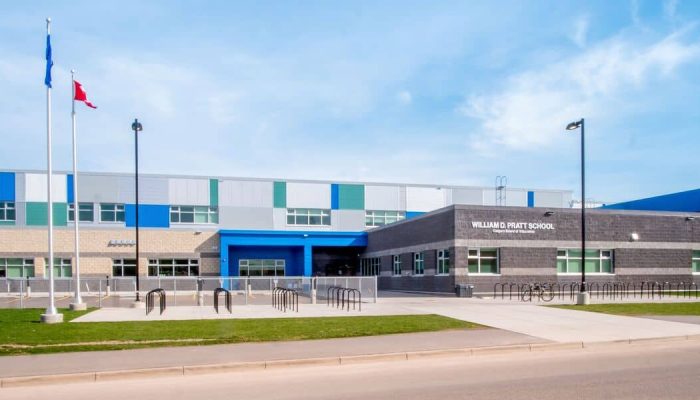 a building that has a sign on the side of a road